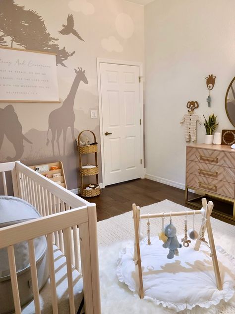 Baby nursery. Neutral nursery. Crib. Safari wallpaper. Customizable canvas. Baby gym. Faux fur rug. Area rug. Olive tree. Baby book shelf. Nursery details. Tap board to shop🤍 Nursery Olive Tree, Botticelli Wallpaper, Book Shelf Nursery, Baby Book Shelf, Nursery Details, Shelf Nursery, Safari Wallpaper, Wallpaper Nursery, Wallpaper Kids