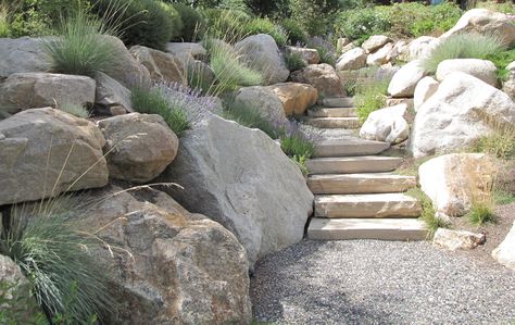 I sense this type of loosley laid boulder wall won't work and it's a bit too loose and messy.  Good to see contrasts of Like, Not so Like. Natural Rock Retaining Wall, Sloped House, Garden Boulders, Stepped Garden, Boulder Wall, Boulder Garden, Boulder Retaining Wall, Rock Retaining Wall, Rock Steps