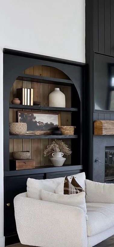 Fireplace Built Ins Black, Black Bookcases Around Fireplace, Bookcase Next To Fireplace Freestanding, Two Tone Built Ins Bookshelves, Modern Tudor House Interior, Wall Of Shelves Living Room, Modern Built In Bookcase, Fireplace With Arched Built Ins, Bookshelves Beside Fireplace