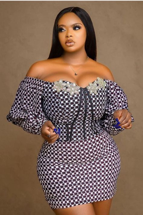 A lady wearing an Ankara gown Ankara Short Gowns Classy, Ankara Short Flare Gowns, Ankara Corset, Short Gown Dress, Ankara Dress Designs, Ankara Short, African Party Dresses, Ankara Short Gown Styles, Dress Ankara