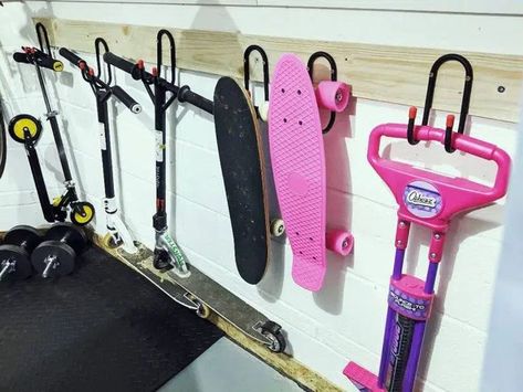 Scooter Storage Ideas Diy, Sport Storage Garage, Roller Skate Storage Ideas, Hockey Storage Ideas, Scooter Storage Garage, Bike And Scooter Storage, Scooter Rack, Scooter Garage, Skateboard Storage