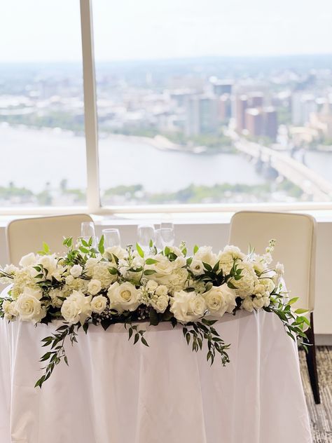 A beautiful sweetheart table with a view! The blooms and lush greenery for this cityscape… I just loved this wedding day. 🌿 More photos to come! 🌼💍 #BostonWedding #CitySkyline #FloralDesign #SweetheartTable #WeddingFlowers #BostonFlorist #DreamWedding #RomanticFlorals #WeddingInspiration #BostonEvents Table Flower Runner, Sweethearts Table, Sweetheart Table Flowers, Flower Runner, Table Flower, White Florals, Wedding Flower Inspiration, Wedding Boston, Sweetheart Table