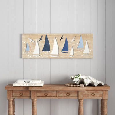 Create an excellent focal point on your walls paired with some cute accent tables, and level up your home with this amazing wall Decor. This wall decor is perfect for a coastal-themed living room, bedroom, or dining room. Wood wall decor makes a great gift for any occasion. Can be hung horizontally using the keyholes; nails and screws are not included. Suitable for indoor use only. This item ships fully assembled in one piece. This is a single brown-colored wall sculpture. Coastal style. | Beach Coastal Wall Decor Ideas Living Room, Diana Lane, Coastal Cottage Decor, Sailboat Wall Decor, Nautical Ideas, Coastal Wall Decor, Coastal Living Rooms, Wooden Wall Hangings, Coastal Living Room