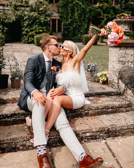 Feather dress, prada sunglasses, colourful bouquet, modern bride #bride #shortdressbride #bridalwear# #prada #weddingfashion Sunglasses With Wedding Dress, Brides With Sunglasses, Short Wedding Dress Sunglasses, Bride In Sunglasses, Bride Sunglasses Wedding, Bride With Sunglasses, Prada Wedding, Sunglasses Bride, Bridal Sunglasses