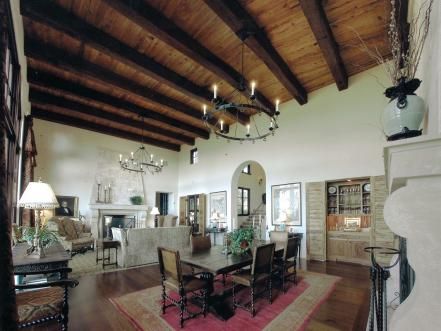 The+open+floor+plan+of+this+Old+World+Spanish-style+interior+allows+for+fluidity+and+simple+design.+The+wooden+ceiling+beams+previously+used+as+supports+now+offer+a+decorative+element.+Round+candle+chandeliers+and+the+arched+doorway+complete+the+Old+World+Spanish+look.+Design+by+Keith+Summerour+of+Summerour+Associates+&+Architects Spanish Dining Room, Spanish Home Interior, Spanish Style Kitchen, Spanish Style Decor, Mediterranean Living Room, Spanish Interior, Spanish Home Decor, Guest Bedroom Design, Spanish Decor