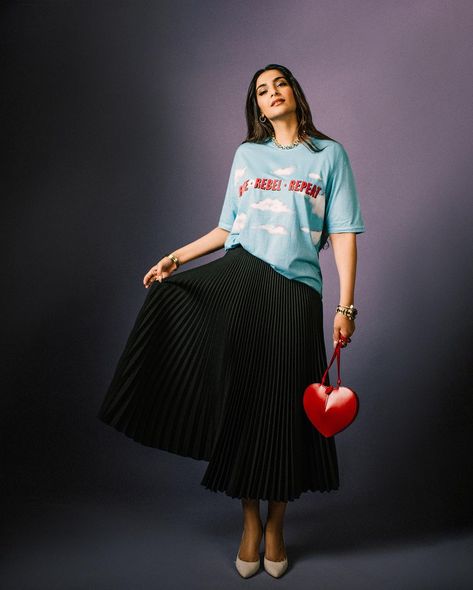 Sonam Kapoor Ahuja embraces a playful elegance with a touch of personal flair Red Checkered Shirt Outfit, Checkered Shirt Outfit, Anand Ahuja, Sonam Kapoor Fashion, Red Checkered Shirt, Black Pleated Midi Skirt, White Pump, Monochromatic Outfit, Pregnancy Looks