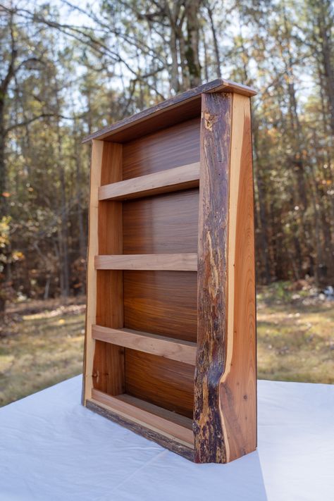 This live edge cedar and oak shelf is the perfect addition to any kitchen, bathroom, or craft room. Perfect for holding spices, essential oils, craft supplies, or any other small item. The live edge gives a it a homegrown rustic feel and the clear finish showcases the natural beauty of eastern red cedar. All items are handmade in upstate SC. Message us on Etsy if you have questions regarding this item. We also make custom items to order including: -Live Edge Furniture -River Tables -Indoor and Outdoor Furniture -Charcuterie Boards -And Much More! Cedar Furniture Diy, Live Edge Diy Projects, Live Edge Bookcase, Live Edge Projects Ideas, Live Edge Cabinet, Live Edge Wood Projects, Live Edge Shelving, Cedar Projects, Live Edge Shelf