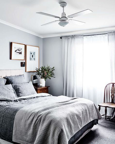 The bedside table in the main bedroom came from the set of 1980s Australian TV show *Carson's Law*, which Kerrie worked on. The bed linen is from Adairs' Vintage Washed Linen range. The large artworks (from left) are by an unknown artist and Louise Rippert. The chair was found in the neighbour's hard rubbish. | Bedroom Ideas For Couples Vintage, Linen Photography, Country Bedroom Ideas, Couples Vintage, Bedroom Design Diy, Home Bedroom Design, Couples Decor, Bedroom Ideas For Couples, Classy Bedroom