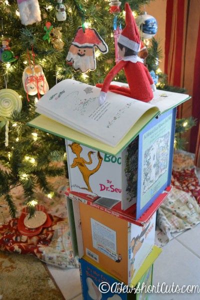 Alphie had himself a read-a-thon last night by the light of the tree. As he read he made a tower wit ... Shelf Tree, Elf Idea, Elf On The Shelf Idea, Elf Magic, Awesome Elf On The Shelf Ideas, Elf Activities, Xmas Elf, Elf Antics, Elf Fun