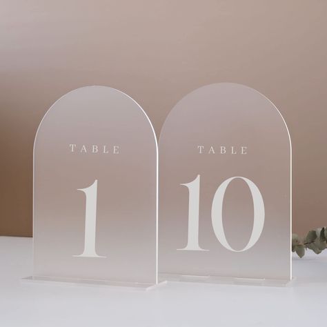 PRICES MAY VARY. PACKAGE INCLUDES: 5x7 inch frosted arch acrylic table numbers 1-10 with frosted acrylic base, total 10 sets in one pack. Each arch acrylic pieces Has A Protective Film On Both Sides To Prevent Scratches and when you are ready to use it, you should peel it off. MINIMALISTIC STYLE DESIGN: These modern minimalistic arched acrylic table number sign are the perfect touch to add to your wedding. We love the sleek, clean lines of these arch acrylic signs, they are a beautiful wedding t Candle Backdrop, Christmas Wedding Favors, Acrylic Table Number, Table Centerpiece Decorations, Wedding Send Off, Candle Wedding Decor, Wedding Program Fans, Acrylic Signs, Arch Wedding