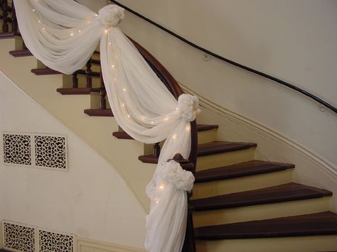 Double staircases decorated for christmas | Washington County, MN -  Official Website - Wedding Planning Wedding Staircase Decoration, Staircase Decoration, Wedding Staircase, Tulle Lights, Wedding Pews, Stairway Decorating, Staircase Decor, Wedding Altars, Stair Decor