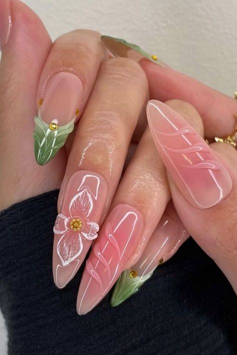 The hues of nude pink and natural green convey innocence and kindness. It’s cute how each nail is unique, with appealing flower and grass features. With a floral light dress and these nails, you’ll seem like a spring princess. //photocredit: @clawsxcollxtion Light Purple Summer Nails, Pink And Blue Aura Nails, Light Pink And Green Nails, Green Pink Nails, Green And Pink Nails, Fairy Nails, Simple Spring Nails, Light Pink Nails, Pink Ombre Nails