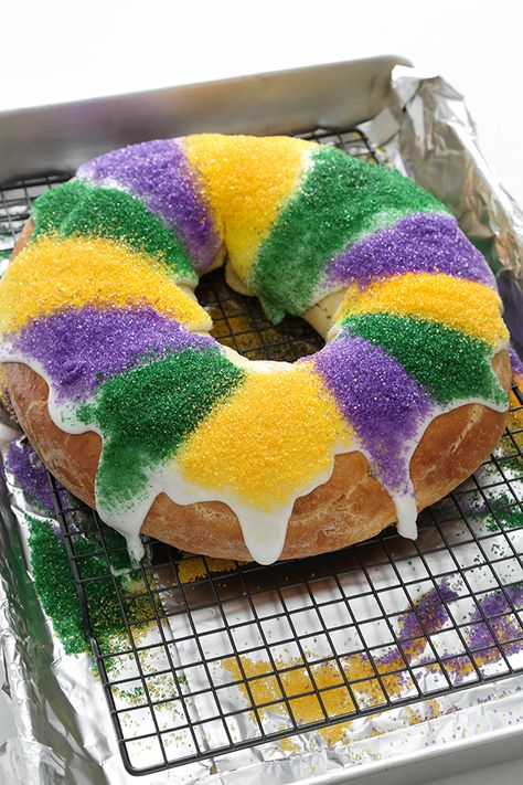 Mardi Gras King Cake Mardi Gras King Cake Recipe, Bread Ring, American Dessert, King Cakes, King Cake Recipe, Mardi Gras King Cake, Cake Liner, Colored Sugar, Holiday Inspo