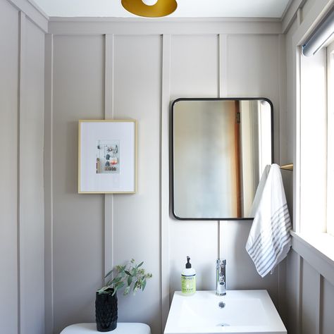 This powder room remodel takes a dated space (with cherubs on the ceiling!) and turns it into a modern classic with board and batten walls and brass accents. Grey Board And Batten Bathroom, Floor To Ceiling Board And Batten Bathroom, Modern Board And Batten Bathroom, Grey Board And Batten Wall, Powder Room Board And Batten, Bathroom Wall Treatments, Board And Batten Powder Room, Grey Board And Batten, Panel Hallway