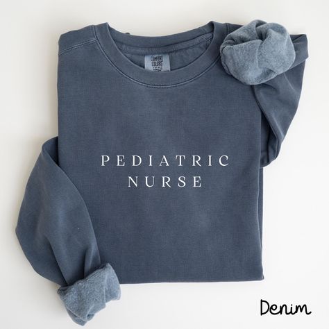 Pediatric Nurse Sweatshirt, RN Sweatshirt, Peds Nurse Sweater, Picu Nurse Shirt, Nurse Practitioner, Registered Nurse Sweater, Peds Er Nurse Each sweatshirt features a relaxed fit, rolled-forward shoulders, and a back neck patch, all in the classic Comfort Colors style. --Sweatshirt Fabric: 80% ring-spun cotton, 20% polyester Weight: Medium-heavy fabric (9.5 oz/yd² or 322.1 g/m²) Fit: Relaxed fit --T-Shirt The sizing is true to size, but please refer to the size chart for exact measurements. If you prefer a t-shirt dress style, consider sizing up by 2 sizes. The design is printed directly onto the fabric, giving it a slightly 'distressed' look. You'll find that the t-shirt material becomes softer after washing! Fabric: 100% ringspun cotton Fit: Loose fit Label: Sewn-in Sizing: True to size Ed Nurse, Emergency Care, Nurse Sweatshirt, Emergency Medicine, Emergency Department, Intensive Care Unit, Emergency Room, Nursing Shirts, Look Plus