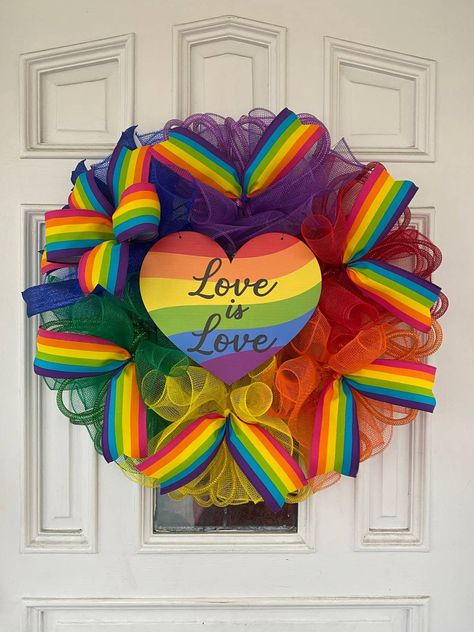 "Beautiful rainbow pride wreath. Also makes a great gift. You will receive the exact wreath shown in the photos. It is approximately 26\" x 28\" wreath that is about 5 to 6\" deep. Will require fluffing out when you take it out of the shipping box to get full size. Wreath measurements include the deco mesh and ribbon when it is properly fluffed out. Made on a 14\" Wire frame. Also available for double door wreaths!! Just select 2 when you check out and message me if you have any special requests Rainbow Wreath Diy, Pride Wreath, Rainbow Wreath, Valentines Day Wreath, Pride Heart, Mesh Wreath Diy, Valentine Day Wreaths, Heart Wreath, Love Rainbow