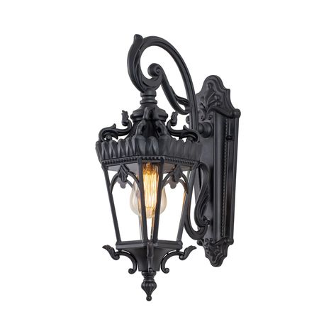 Blending traditional style in a classic design with this outdoor wall light. Inspired in castle, the lantern features an exquisite design with detailing in a classic matte black finish, descends from elaborate, sweeping swirls and curves. Angled, beveled clear tempered glass complements the gracefulness of the curvatures. The lantern hangs from a decorative scroll arm and is firmly affixed to the matching wall plate. Made from aluminum, this wall light ensures long-lasting durability and resista Exterior Light Fixtures, Black Outdoor Wall Lights, Black Light Fixture, Goth Home Decor, Outdoor Wall Lantern, Gothic Home Decor, Porch Lighting, Wall Lantern, Outdoor Wall Lights