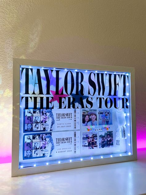 taylor swift eras tour shadow box with led lights that change color, eras tour tickets, light up wristband, friendship bracelets, cute pics, and confetti! Taylor Swift Valentines Box For School, Valentines Box Taylor Swift, Valentines Box Ideas Taylor Swift, Concert Shadow Box Ideas Kpop, Taylor Swift Box Gift, Valentine Box Ideas For School Taylor Swift, Eras Tour Memory Ideas, Eras Tour Display, Eras Tour Decor