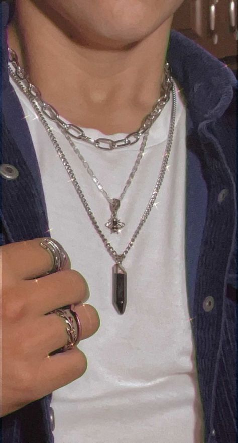 This image is a closeup of men’s jewelry. I am wearing a dark blue corduroy long sleeve shirt that is unbuttoned and a white undershirt. I am wearing three necklaces the shortest is a silver thicker chain link necklace. The second is a thinner silver necklace with a black and silver bee pendent. The third and longest is another silver necklace with a black obsidian crystal. I have one silver ring on my index finger and two on my ring finger Mens Chains, Modern Y2k, Y2k Mens, Rings And Necklaces, S Jewelry, Y2k Fashion, Chain Necklace, Jewelry Rings, Fashion Inspo