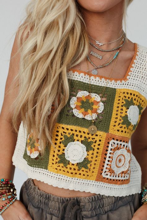 You'll add a touch of nostalgic charm to every outfit with our Fair And Square Crochet Top -a unique and eye-catching look that's perfect for warm weather days or festival season! You'll love adding a bohemian twist to your everyday style in this top because it features: Comfortable and cute crochet fabric with colorful square details Relaxed and loose, cropped length silhouette Classic square neckline with thick tank straps So cute crochet flower details throughout Scalloped edges along the nec Crochet And Sewing Combined, Granny Square Top Crochet, Colorful Crochet Top, Bohemian Twist, Boho Essentials, Floral Mosaic, Padded Bralette, Crochet Fabric, Square Crochet