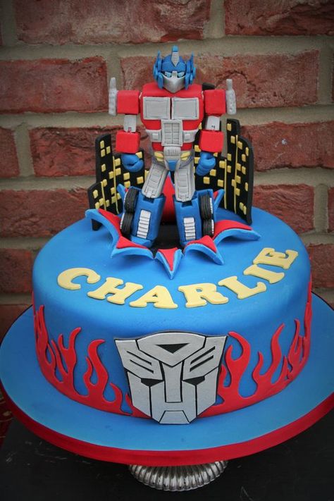 Optimus Prime birthday cake made by Sam Hallé Cakes Rescue Bots Birthday Cake, Transformers Birthday Cakes, Optimus Prime Birthday Cake, Transformer Cakes For Boys, Transformers Cake Ideas, Prime Birthday Cake, Transformers Cake Optimus Prime, Rescue Bots Cake, Optimus Prime Birthday