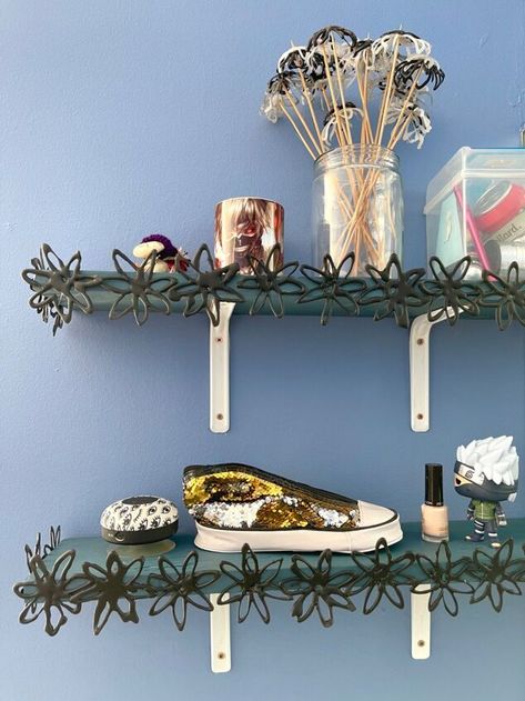 It’s really easy to apply the idea of the Urban Outfitters Shania picture ledge to any shelf at pretty much no cost. Use a glue gun to make fake wrought iron flowers. Then apply them to any shelf, floating or not, broad or narrow. That’s it, tutorial over.Above are the shelves at my daughters desk. Not the prettiest. The brackets were added recently because the shelves dipped and taking anything down again for painting was going to cause hassles, so I decided to prettify them as they… Shelf Painting Ideas, Shelf Painting, Picture Ledge Shelf, Ledge Shelf, Shelf Floating, Simple Flower Design, Poor Man, Picture Ledge, So Creative