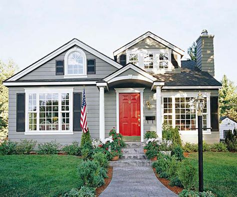 An all neutral facade gets a fun update with a bold red door. See more entryway makeovers: http://www.bhg.com/home-improvement/exteriors/curb-appeal/entryway-designs/?socsrc=bhgpin041613reddoor=2 Red Door House, Casas Country, Door House, Red Front Door, Black Shutters, Gray House, Grey House, Window Trim Exterior, Grey Houses