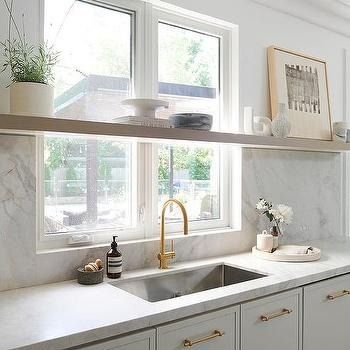 Shelf In Front Of Kitchen Window Design Ideas Open Shelves Kitchen Window, Shelves In Front Of Kitchen Window, Shelf Over Sink, Marble Slab Backsplash, Shelf Above Window, Long Floating Shelf, 2025 Kitchen, White Farm Sink, Stainless Steel Apron Sink