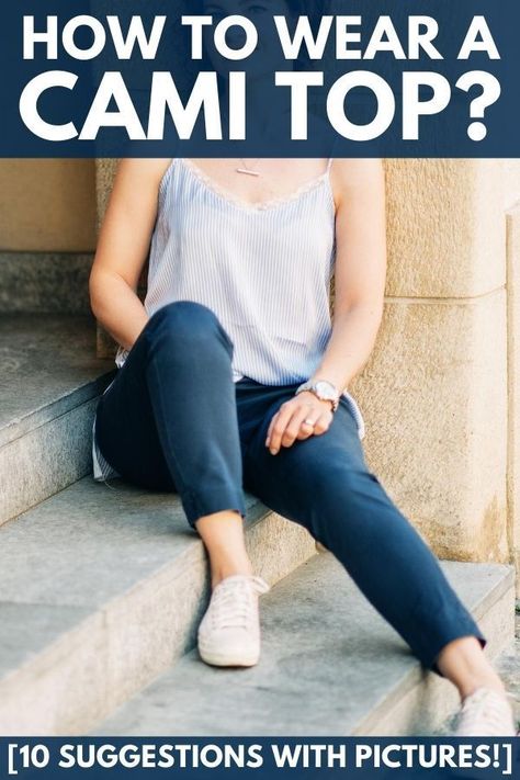 Outdoor portrait of beautiful woman wearing camisole top and jeans sitting on stairs. The camisole, also known as a cami top or cami is an incredibly versatile piece of clothing to have in your closet. It can be worn alone, used for layering, or to add an accent of color or texture to an outfit. Read our guide to know the best way to wear a cami top. Bra For Cami Top, Camisoles Outfits, White Camisole Outfit, White Cami Outfit, Silk Camisole Outfit, Silk Cami Outfit, Camisole Top Outfit, Sitting On Stairs, Camisole Outfit