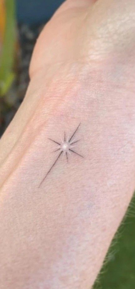 Star Tattoos On Back For Women, Small Star Burst Tattoo, Star With Name Tattoo, North Star Tattoo White Ink, Memorial Star Tattoos, Twinkling Stars Tattoo, Northstar Tattoo Design, Small North Star Tattoos, Art Deco Star Tattoo