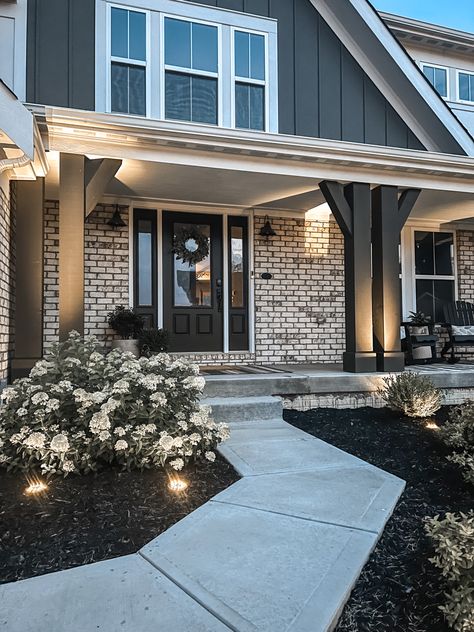 Uplighting Landscaping, Black Front Porch Columns, Black Pillars On Front Porch, Black Porch Columns, Front Porch Walkway Ideas, Gray Brick House Exterior, Modern Farmhouse Front Porch Decor, Outdoor Uplighting, Gray Porch