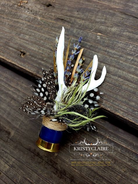 Custom Half Navy Blue Shotgun Shell Boutonnieres with Antlers, Lavender, Guinea Hen Feathers & Thistle 💙
WWW.KRISTYCLAIRE.ETSY.COM 
www.kristyclairefloraldesign.com 
#weddingboutonniere #weddingdecor #wedding #weddingcorsage #weddingparty #weddingdesign #newzealand #shotgun #shotgunshells #antlers #antlerdecor #antlerart #hunting #unique #lavender #thistle #polkadots #guineafowl #newzealandlife #newzealandphotography #thankyou #fauxantlers #mini Western Wedding Boutonniere, Hunting Boutonniere, Shotgun Shell Boutineer, Shotgun Shell Boutonniere Diy, Antler Boutonniere, Fishing Boutonniere, Bullet Boutonniere, Hunting Wedding Theme, Boutineer Ideas