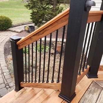 Browse the DecksDirect deck railing photo galleries to see different railing materials including metal railing, wood railing, cable railing, composite railing and more! Shop today! Wood And Iron Porch Railing, Wood And Black Porch Railing, Front Railing Design Modern, Colonial Deck Railing, Black Front Porch Railing Wood, Front Porch Black Railing White Houses, Front Porch Railing Ideas Wrought Iron And Wood, Front Porch Wooden Railing Ideas, Wood And Black Front Porch