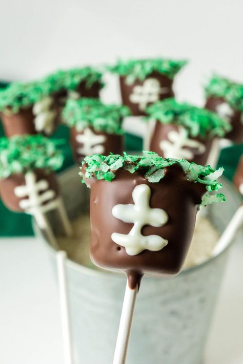 Serve up these easy no bake football marshmallow pops. A fun football themed dessert you can enjoy for your next big game. These are a great game day dessert for you to try out for your next big game. Football Themed Desserts, Football Desserts, Football Things, Chocolate Footballs, Marshmallow Desserts, Popular Desserts Recipes, Chocolate Dipped Marshmallows, Flavored Marshmallows, Marshmallow Dip