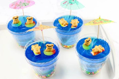 Since we are on a roll with cute mini desserts, let's sneak in a fun summer dessert that the kids will absolutely adore..Beach Days Jello Cups Recipe. Sea Snacks, Beach Desserts, Bible School Snacks, Summertime Desserts, Beach Dessert, Gummy Fish, School Kitchen, Jello Cups, Blue Jello