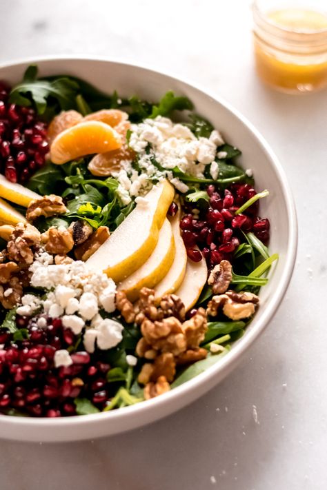 Winter Salad with Pears and Pomegranate - A stunning winter salad made with greens, pomegranate, pears, and oranges - and finished off with walnuts, feta cheese, and a delicious 4 ingredient dressing! So quick + delicious! #pomegranate #pear #winterrecipes #salad #glutenfree #healthyrecipes #vegetarian #easyrecipes #bluebowlrecipes | bluebowlrecipes.com Salad With Pears, Winter Salad Recipes, Winter Salad, Blue Bowl, 4 Ingredient, How To Make Salad, Healthy Salads, Winter Food, Delicious Salads