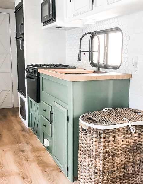 Peek inside this modern farmhouse-inspired RV renovation from @rv.family.reno, a quarantine DIY project that sparked a new business venture! #RVrenovation #camper #glamping #rvinspiration #rvredo #rvreno #tinyhome #moderncamper #designvibes #forestriver #modernfarmhouse #tinyhome #campermakeover #camperrenovation Kitchen Cabinet Green, Renovated Rv, Caravan Vintage, Glamper Camper, Rv Van, Rv Interior Remodel, Small Camper, Tiny House Camper, Camper Trailer Remodel