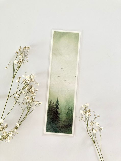 - DESCRIPTION -  One bookmark featuring my original watercolour forest painting. The perfect companion for wherever your next reading adventure takes you!  Printed on fine art paper using archival inks and laminated for protection. Perfect as a gift for any occasion: Christmas, birthday, anniversary etc. or to treat yourself.    Bookmarks will be packaged securely inside a clear sleeve in a rigid cardboard mailer for protection.  **Please note that colours may vary slightly from what you see on your screen.  **Features my original watercolour painting.  Dimensions - 5.5 x 19cm approximately  Thank you for visiting my shop! All artworks are painted with love by me in my studio. Please feel free to contact me if you have any questions.  Follow me on instagram for updates and more: @jodieoste Forest Bookmark, Watercolour Notebook, Watercolour Forest, Watercolour Bookmarks, Nature Bookmarks, Bookmark Ideas, Christmas Bookmarks, Watercolor Books, Reading Adventure