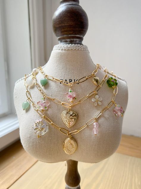 We ship worldwide. Gabi The Label, Handmade Jewelry Business, Gold Heart Locket, Flower Charm Necklace, Aventurine Crystal, Oval Locket, Gold Locket, Dope Jewelry, Locket Charms