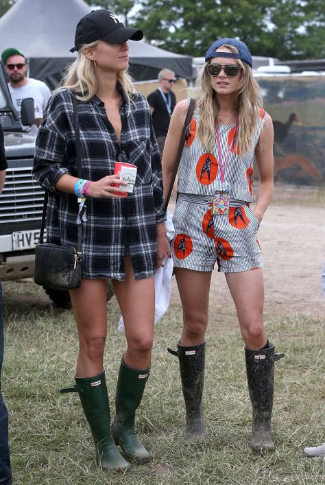 Cressida Bonas (Prince Harry's ex) battles the infamous Glastonbury mud and rain with wellington boots and a backwards hat.