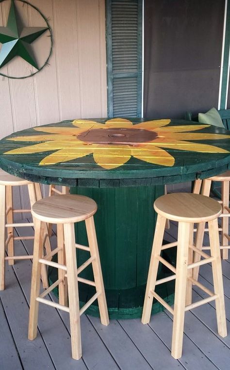 This is a spool I was lucky enough to see someone discarding. It is very large and very, very heavy. It took using our tractor to move it. This is the finished paint job but I plan on adding a self leveling epoxy to the table top & embellishments like some rope around the edge of the table. These stools are extras I had sitting around but I plan on painting them and making cushions for the top. More pics to come later. Wooden Spool Table Ideas, Bar Stool Painting Ideas, Large Wooden Spool Ideas Outdoor, Large Wire Spool Ideas, Large Wooden Spool Ideas, Large Spool Projects, Spool Table Ideas, Spool Projects, Wire Spool Tables