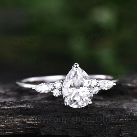 "This is a moissanite engagement ring in solid gold,about 6x8mm pear cut. The accent stones are round 1.5mm and marqueise 2x4mm moissanites. The matching bands stones are round 2mm and marqueise 1.5x3mm moissanites. Only the engagement ring: https://www.etsy.com/listing/974420284/pear-shaped-moissanite-engagement-ring It can be made in any ring size. However please contact me to custom make it to a special big or small size. It can be made in white gold,rose gold or yellow gold with 14k or 18k. Pear Cut Engagement Ring Silver, Rain Drop Wedding Rings, Silver Engagement Rings Pear, Silver Pear Shaped Engagement Ring, White Gold Pear Engagement Ring, Pear Engagement Ring Silver, 3 Carat Moissanite Engagement Ring, Small Simple Engagement Rings, Gold Ring Women