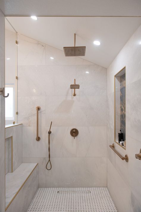 Transform your shower into a luxurious retreat with this stunning Calacatta Gold marble tile on the walls, paired beautifully with basketweave marble mosaic flooring. The warm brass fixtures perfectly complement the timeless elegance of the marble, making this space both sophisticated and serene. Let us help you transform your space. #BathroomInspiration #MarbleTile #CalacattaGold #LuxuryBathroom"​ Gold Marble Bathroom, Calacatta Oro Marble, Marble Shower Tile, Calacatta Gold Marble, Marble Showers, Classic Tile, Calacatta Gold, Brass Fixtures, Mosaic Flooring