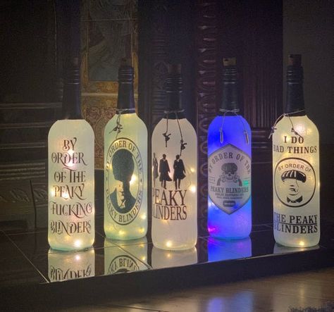 Beautiful handmade Peaky Blinders light up wine bottles. Perfect for Christmas/Birthday gifts. Available in a number of designs. Each bottle includes gun/bullet accent charms around the neck of the bottle. Each bottle contains a cord of LED lights so there are no external wiring to worry about. Peaky Blinders Gifts, 100th Birthday Party, Light Up Bottles, Crushed Diamonds, Accent Lamps, Diy Jar Crafts, Diamond Bling, 18th Birthday Gifts, Glam Decor