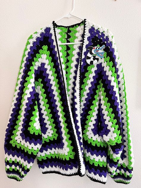 Hexi Cardi - colors inspired by Beetlejuice  Crochet Hexagon Granny Square Cardigan handmade by me! Takes me 40 hours to complete. This is a size X-Large.  Arm length from armpit to wrist is 19 inches  Length from top to bottom 28 1/2  inches  back armpit to armpit 27 1/2 inches if you would like the patch added to the Cardi please send me a message once ordered.  Made from 100% acrylic yarn. Hand wash or machine was in delicate cycle and lay flat to dry. Ready to ship 📦 Beetlejuice Granny Square, Hexicardigans Crochet, Crochet Beetlejuice Cardigan, Skull Granny Square Cardigan, Crochet Beetlejuice Pattern Free, Halloween Crochet Cardigan, Beetle Juice Crochet, Crochet Hexagon Granny Square, Hexagon Granny Square Cardigan