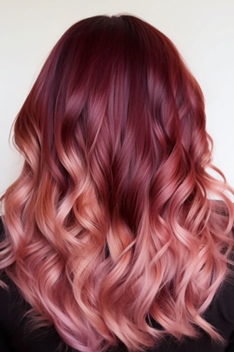 Transitioning from burgundy to a softer rose gold, this ombre look is a captivating bright burgundy balayage option. It’s best for those with mid-length hair and works well with a middle part. Click here to check out more stunning burgundy balayage hair ideas trending right now. Burgundy To Rose Gold Ombre Hair, Burgundy To Pink Ombre Hair, Maroon Blonde Balayage, Burgundy Shadow Root, Burgundy Hair With Blonde Face Frame, Burgundy And Rose Gold Hair, Mid Length Haircut Red Hair, Copper Red Hair Color Balayage Rose Gold, Red To Pink Balayage