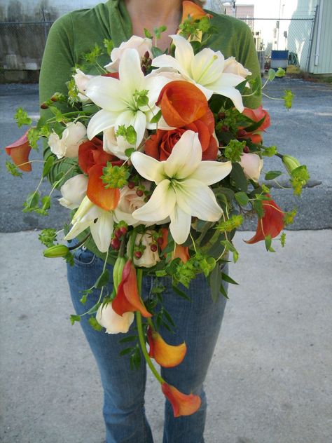 Orange calla lilies, giant white lilies, cream roses and red hypericum combine to make this stunning Autumn bouquet.    Jen-Mor Florist, Dover, DE www.jenmor.com Fall Calla Lily Bouquet, Calla Lily Centerpieces, Tiger Lily Wedding, Poppy Bouquet, Autumn Bouquet, Bride Ideas, Calla Lily Bouquet, Winter Wedding Bouquet, Budget Bride