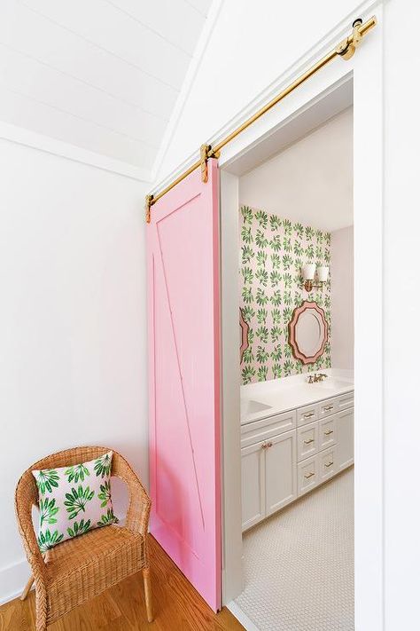 A wicker chair topped with a white and green pillow sits outside of a pink barn door on a brass rail. Pink Doors, Pink Bathrooms, South Shore Decorating, Room Cozy, Pink Door, Preppy Room Decor, Preppy Room, Pink Bathroom, Decor Aesthetic