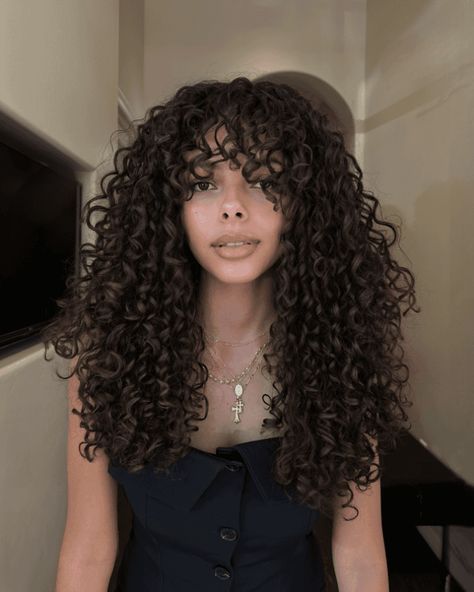 39 Curly Shag Hairstyles With Bangs For Extra Volume Curly Sew In With Bangs, Curly Hair W Bangs, Curly Long Hair With Bangs, Long Curly Haircuts With Bangs, Curly Bangs Long Hair, Wispy Curly Bangs, Layered Curly Hair With Bangs, Haircuts For Thick Curly Hair, Curly Shag Hairstyles