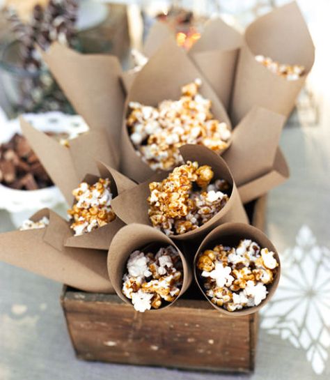 The secret to this salty-sweet snack? Ready-made caramel syrup, melted and drizzled over popcorn. Serve it in Kraft-paper cones. Sledding Party, Chocolate Covered Popcorn, Salty Sweet Snacks, Winter Parties, Caramel Syrup, Paper Cones, Caramel Popcorn, Snacks Für Party, Winter Party